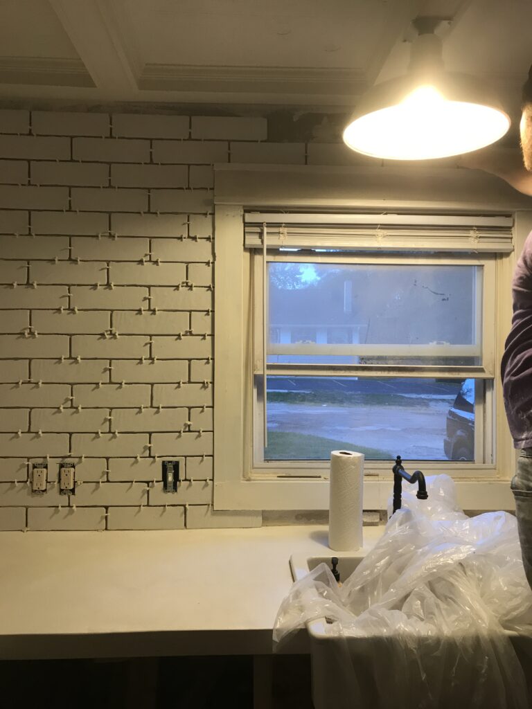 White faux brick tile backsplash for my old kitchen. Has the perfect old-world look, yet still new and fresh. The perfect porcelain tile backsplash.