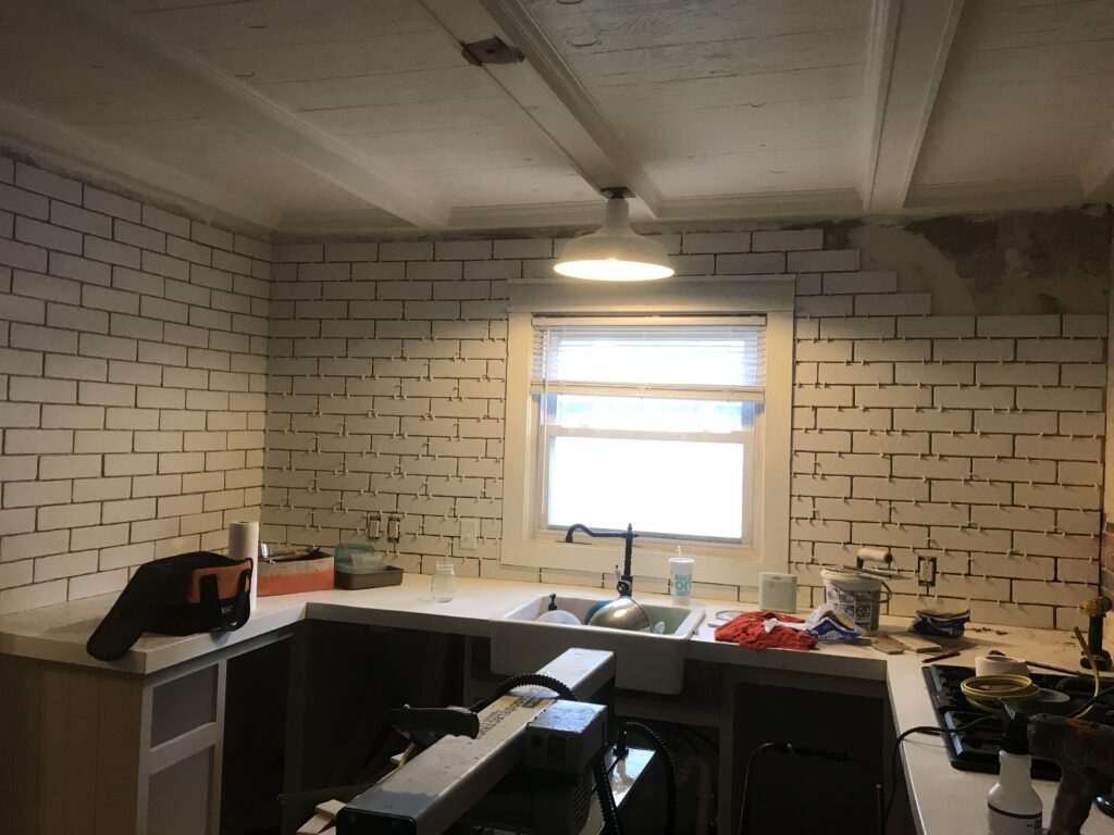 White faux brick tile backsplash for my old kitchen. Has the perfect old-world look, yet still new and fresh. The perfect porcelain tile backsplash.