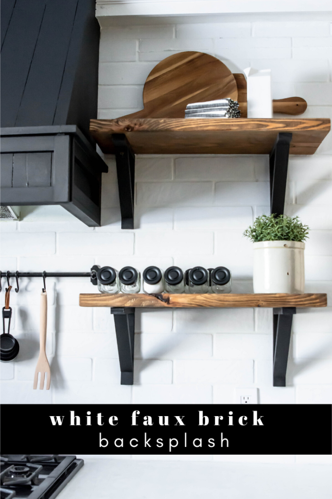 white faux brick backsplash. Floor to ceiling kitchen backsplash. White tile black vent hood kitchen. Open shelving kitchen. Kitchen open shelving.