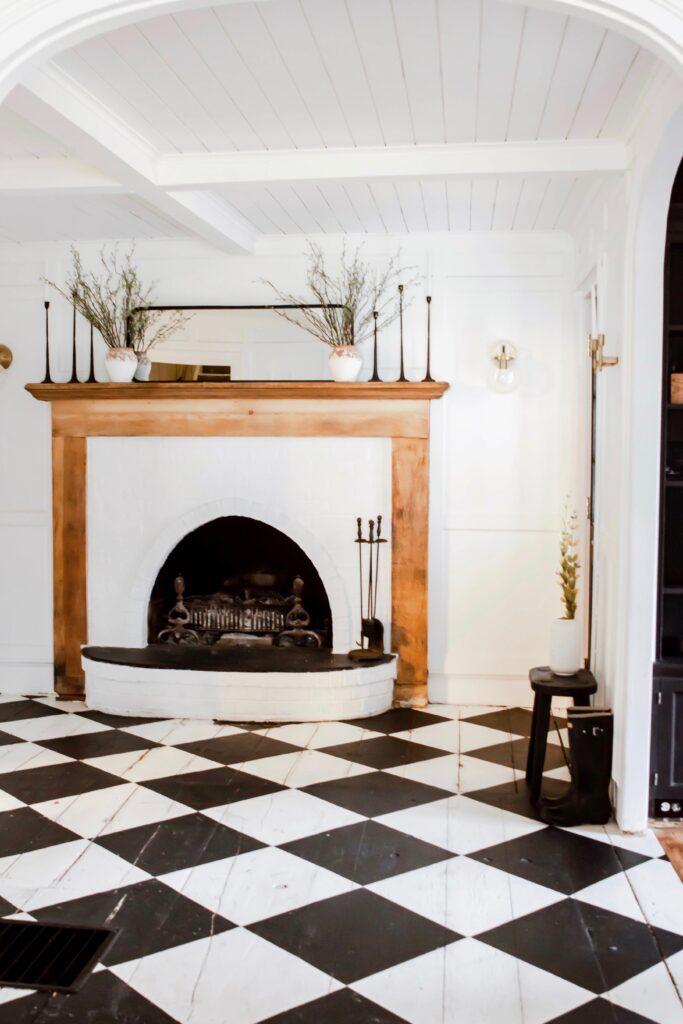 Painted Checkboard Floor on hardwood flooring. Easy flooring udpate. Budget flooring update. Old farmhouse floors. Harlequin flooring. Harlequin floors. Black and white floors.