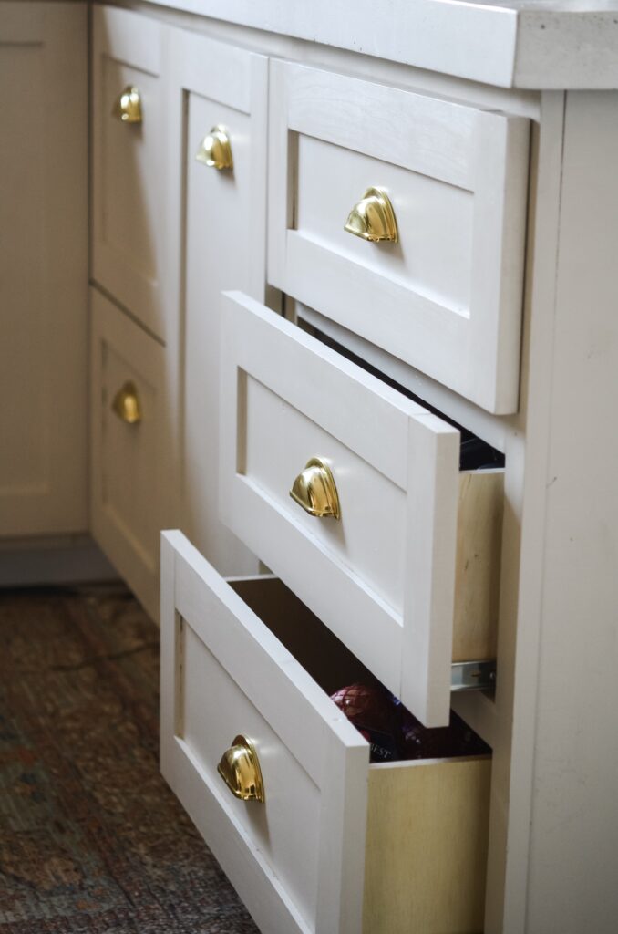 mushroom cabinets with brass hardware