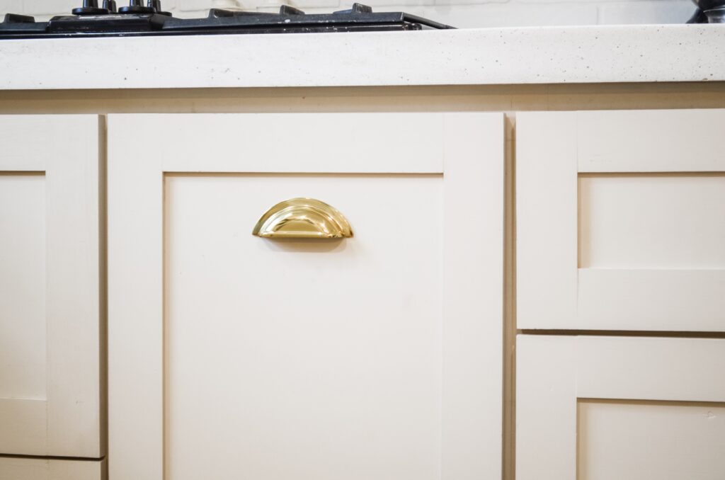 Beautiful brass cabinet pulls on mushroom cabinets