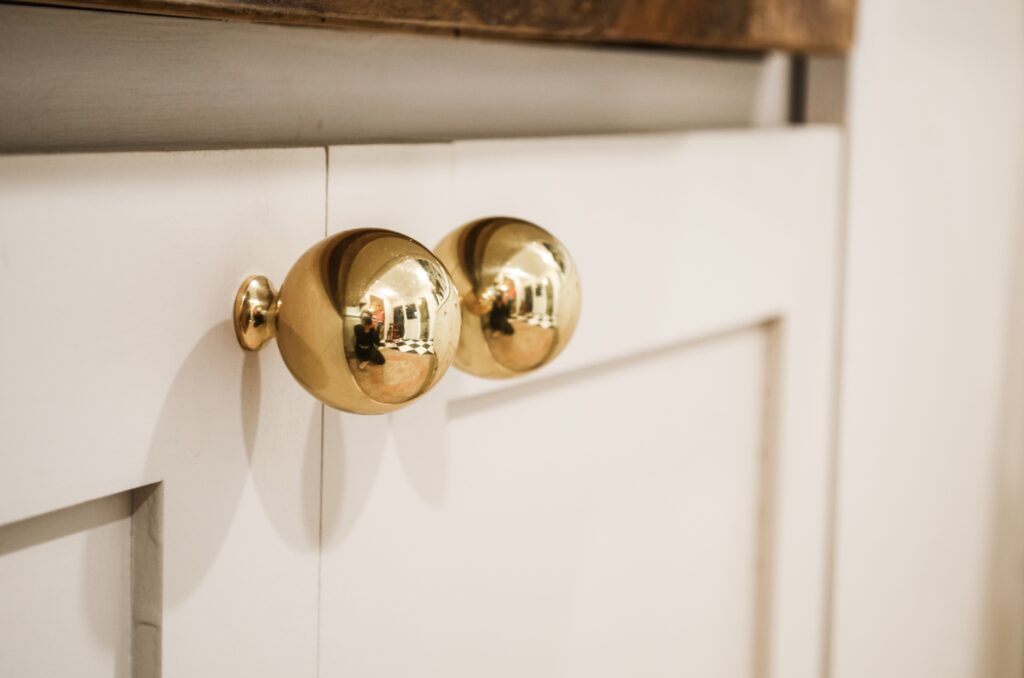 brass and mushroom cabinet combo