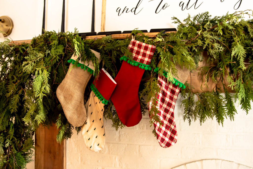 Christmas stockings in varying colors. Red, green, and burlap Christmas stockings.