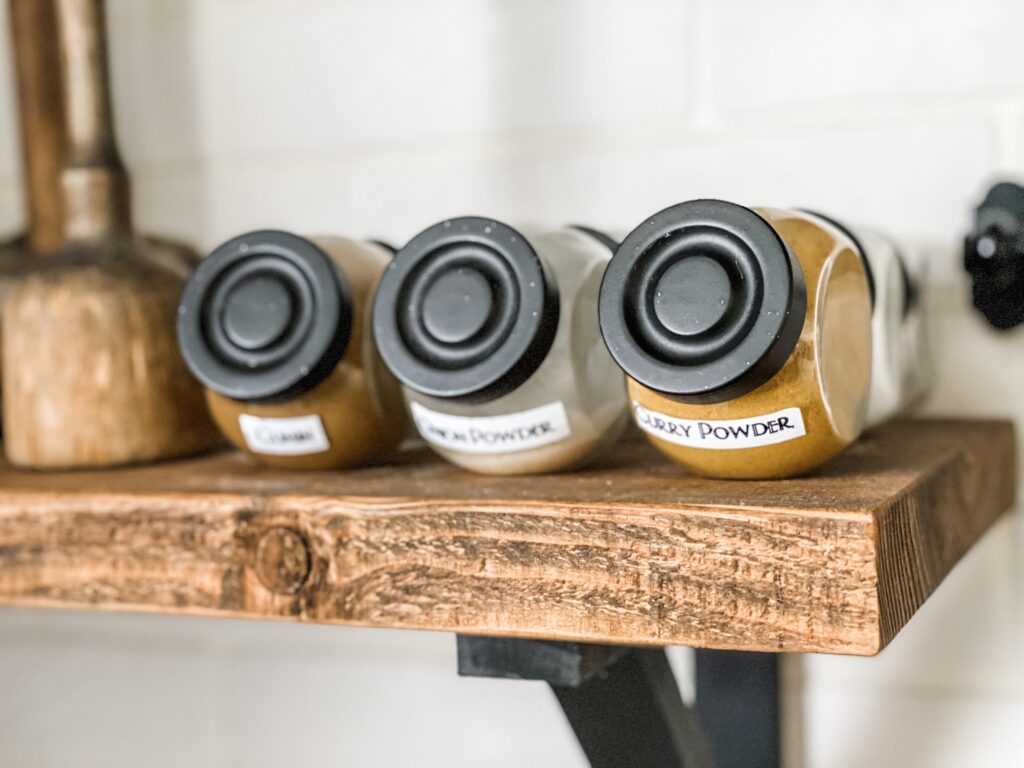 Open shelving with uniform spice jars.

#diy  #cricut #cricutmade #label #organize #spicejars #kitchenorganization 