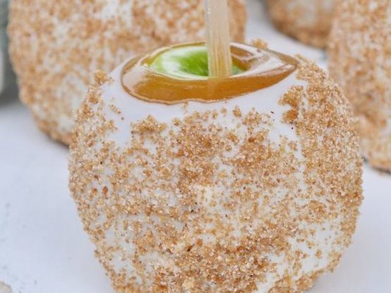 Homemade gourmet caramel apples dipped in white chocolate and topped with sugar and cinnamon.
